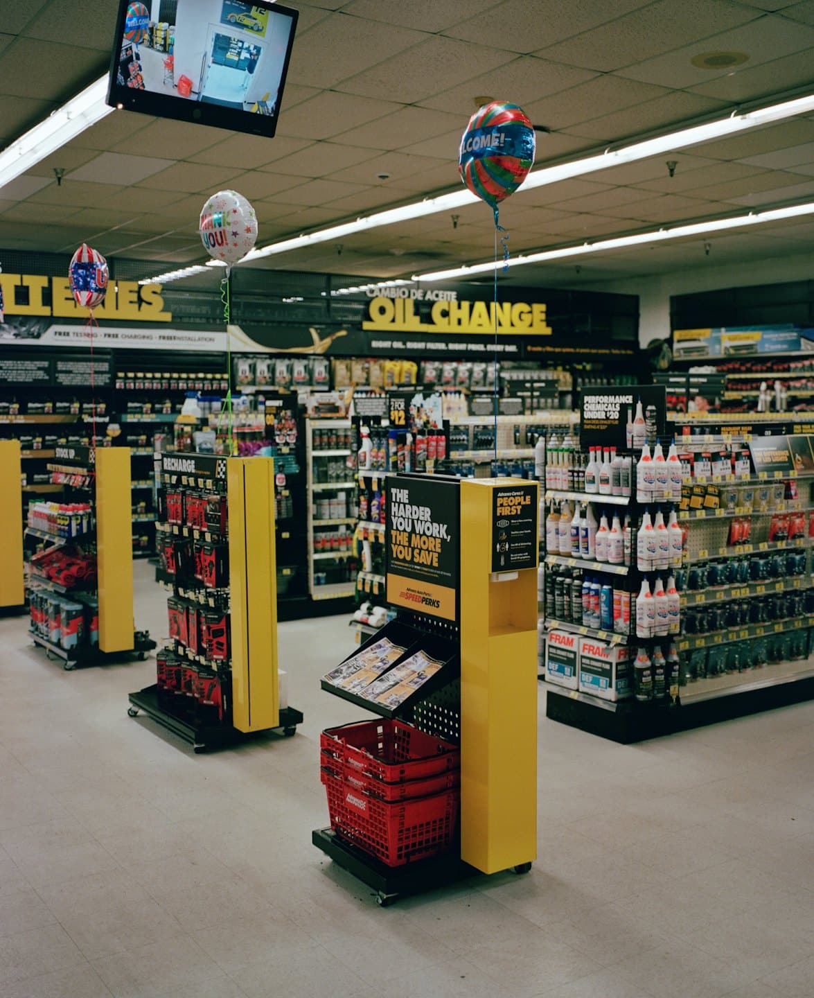 An auto parts store with aisles of automotive products on shelves.