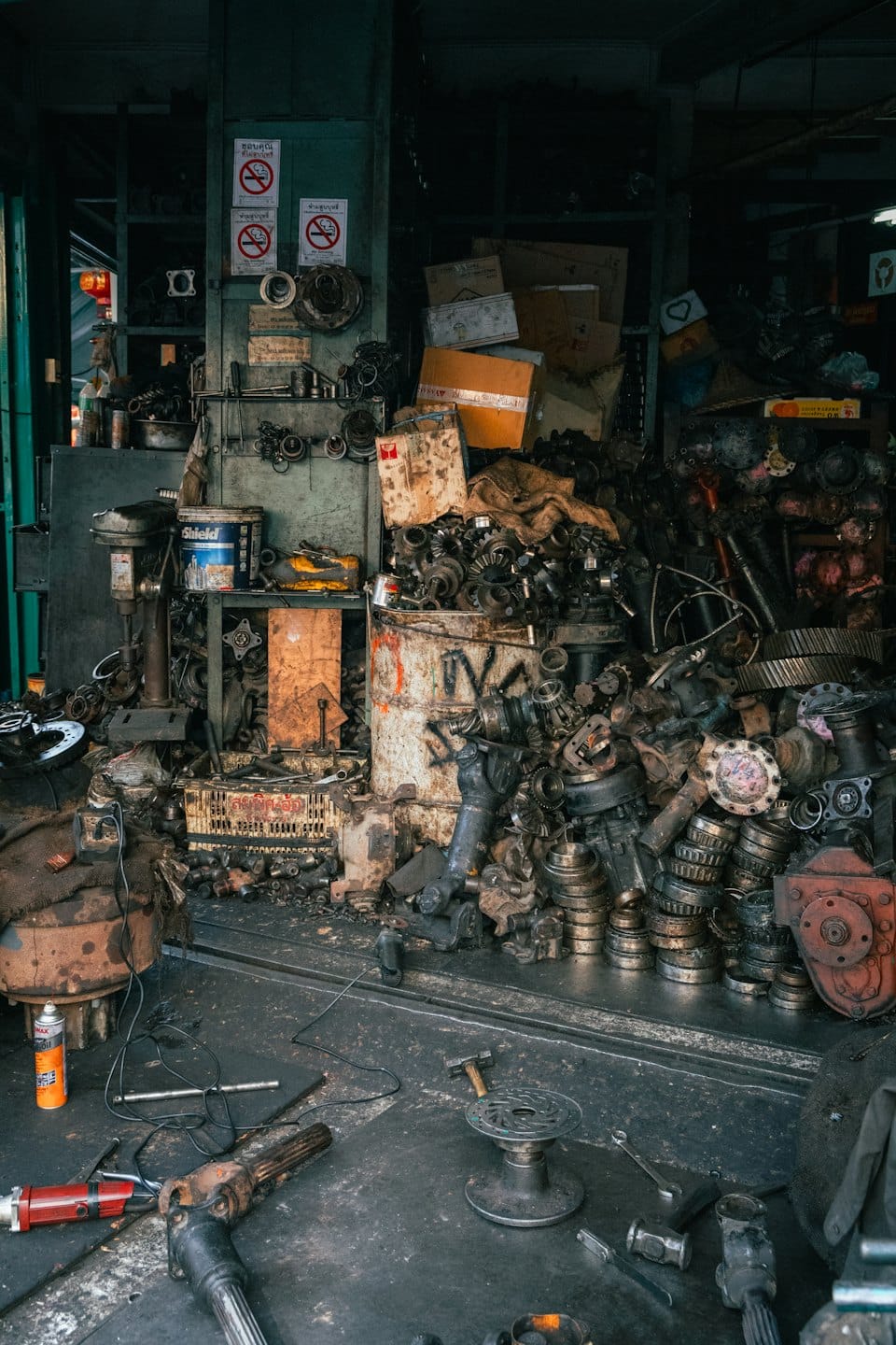 Mechanical parts and tools fill a crowded auto repair shop.