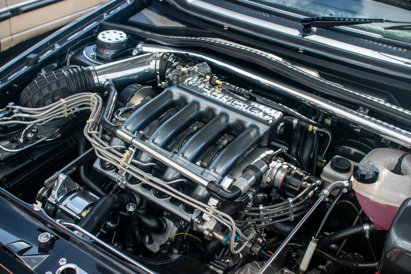 Clean car engine with polished metal parts and wiring.